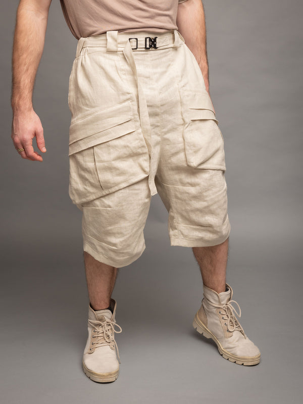 Zyrex drop crotch knee length shorts in sand with 8 pocket design - Front side view paired with linen belt 