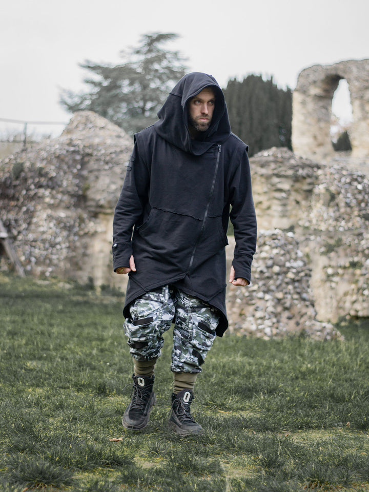 Arakion Mens Asymmetric Zip Up Hoodie with Thumbholes and Distressed Details in Black - full body image of the hoodie styled with the Stealth Cargos