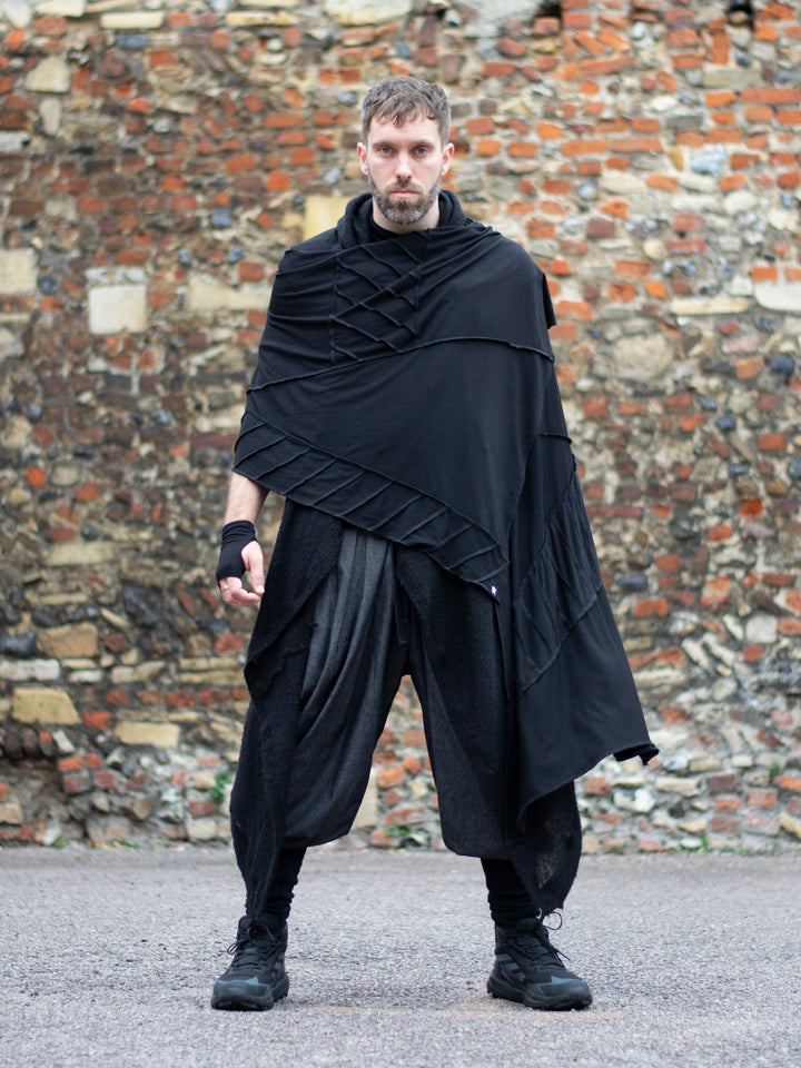 Oversized black bamboo scarf with overlock stitching, styled as a draped wrap. Futuristic and flowy, with a post-apocalyptic edge. Breathable, lightweight, and versatile for layered looks.