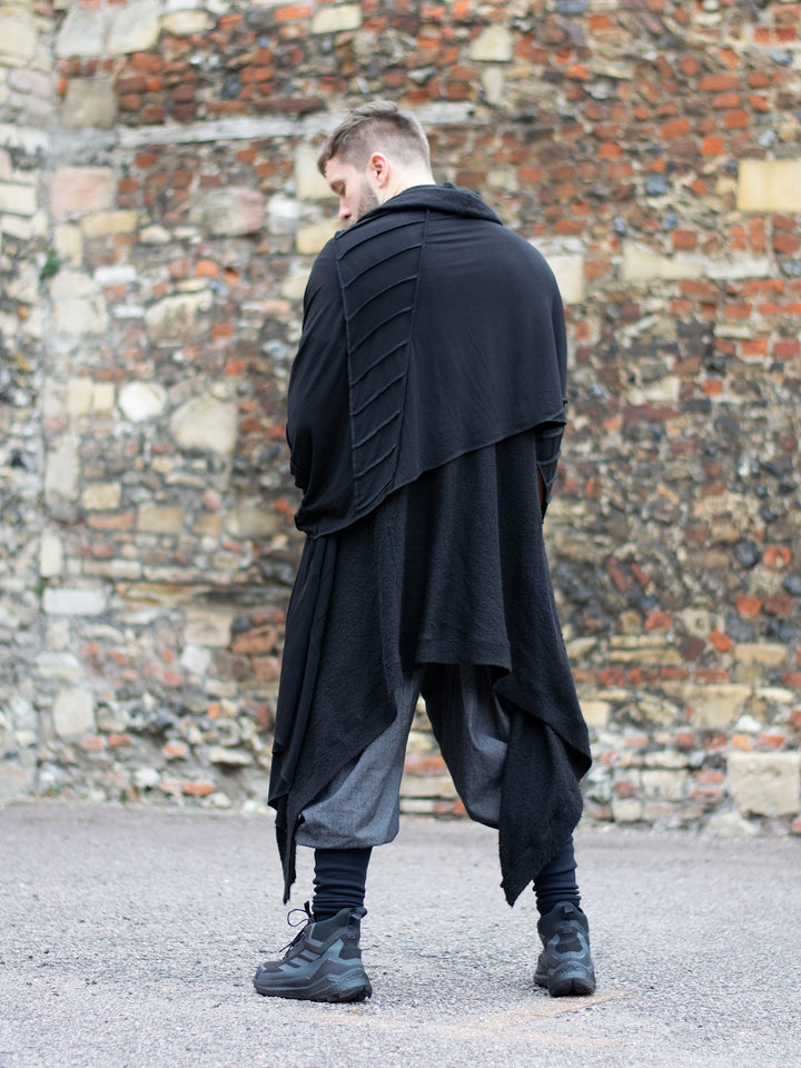 Oversized black bamboo scarf with overlock stitching, styled as a draped wrap. Futuristic and flowy, with a post-apocalyptic edge. Breathable, lightweight, and versatile for layered looks.