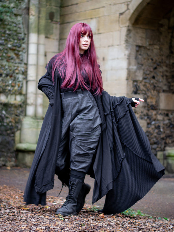 Athos - an avant garde oversized scarf in a premium chain knit material, with abstract panels and overlock stitch details for a raw alternative look. Paired with combat boots and cargo pants.