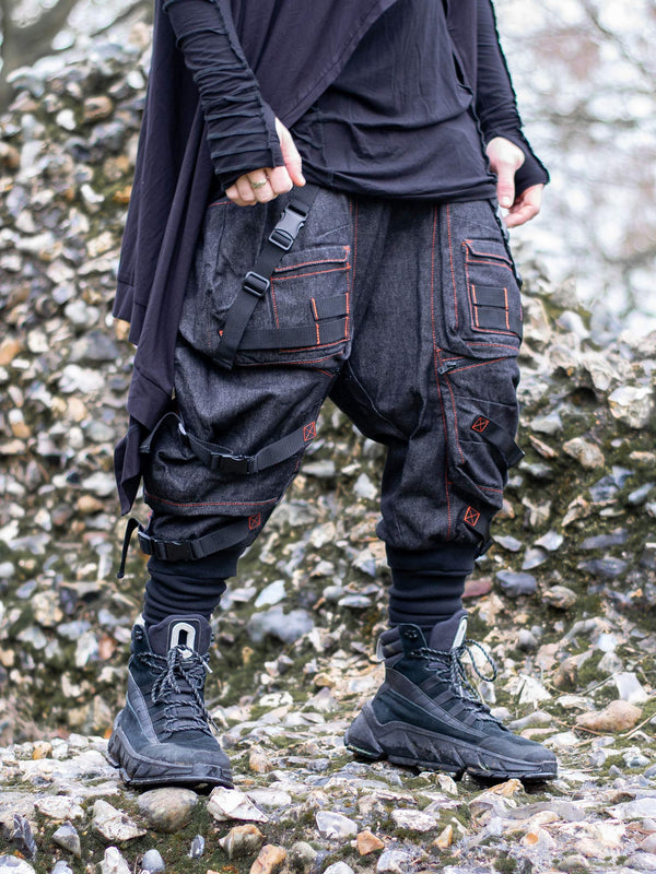 Kraken Men's Drop Crotch Cargos with 10 Pocket Design, Metal Buckles and Contrast Orange Stitching. Design combines streetwear with techwear and darkwear elements for a rugged aesthetic. 