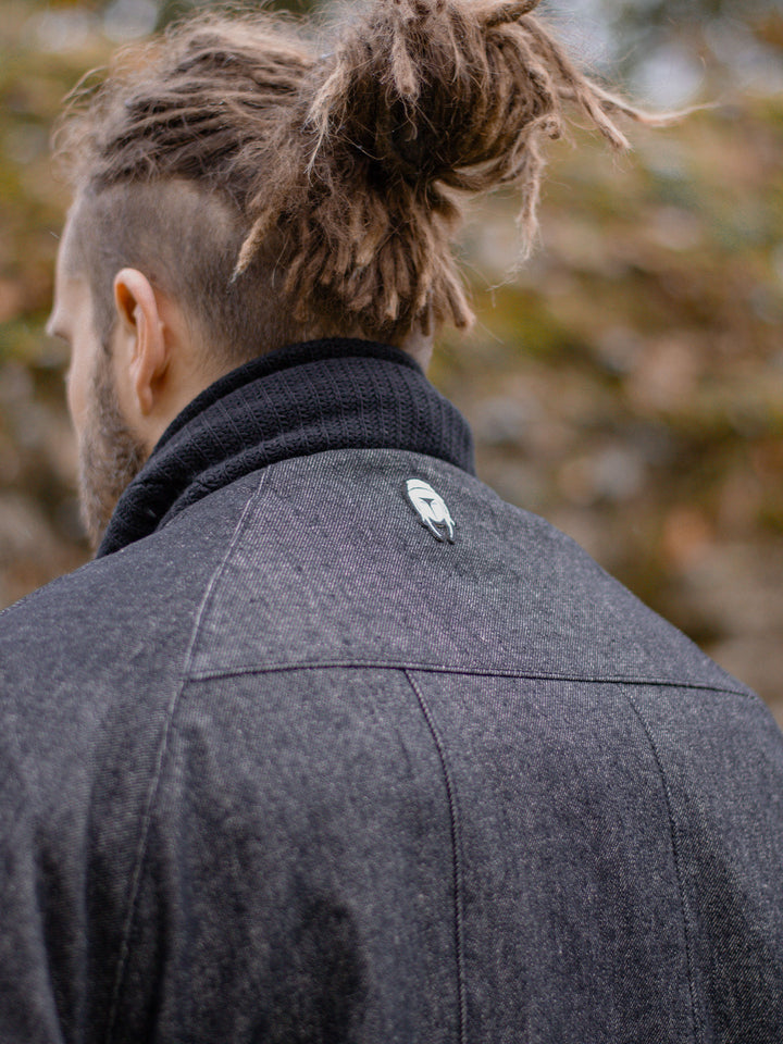 Kronos Men's Oversized Bomber Jacket with 10 Pocket Design, Metal Buckles and Thumbholes - Close up of the bag patch logo