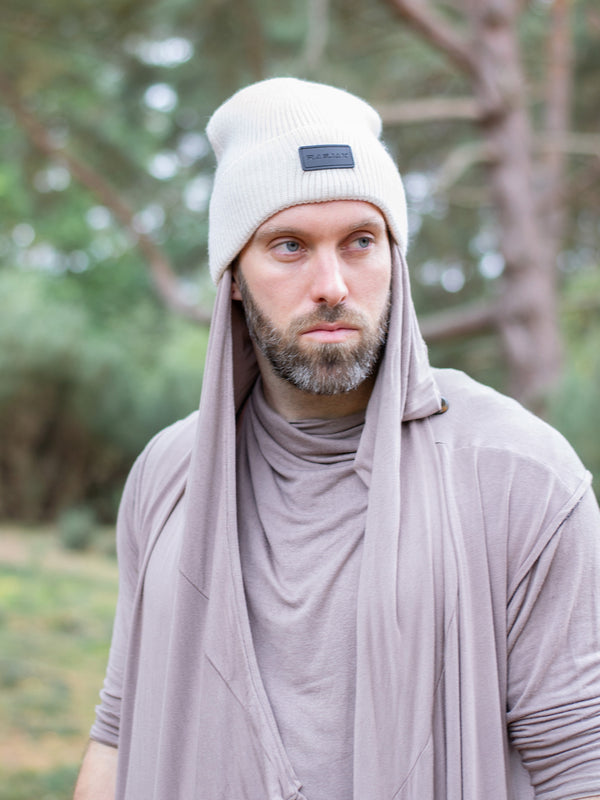 Close-up of a ribbed knit Merino wool beanie in cream, featuring a turn-up cuff and a RagJak leather tag on the fold-up. A versatile and stylish winter accessory designed for warmth and durability.