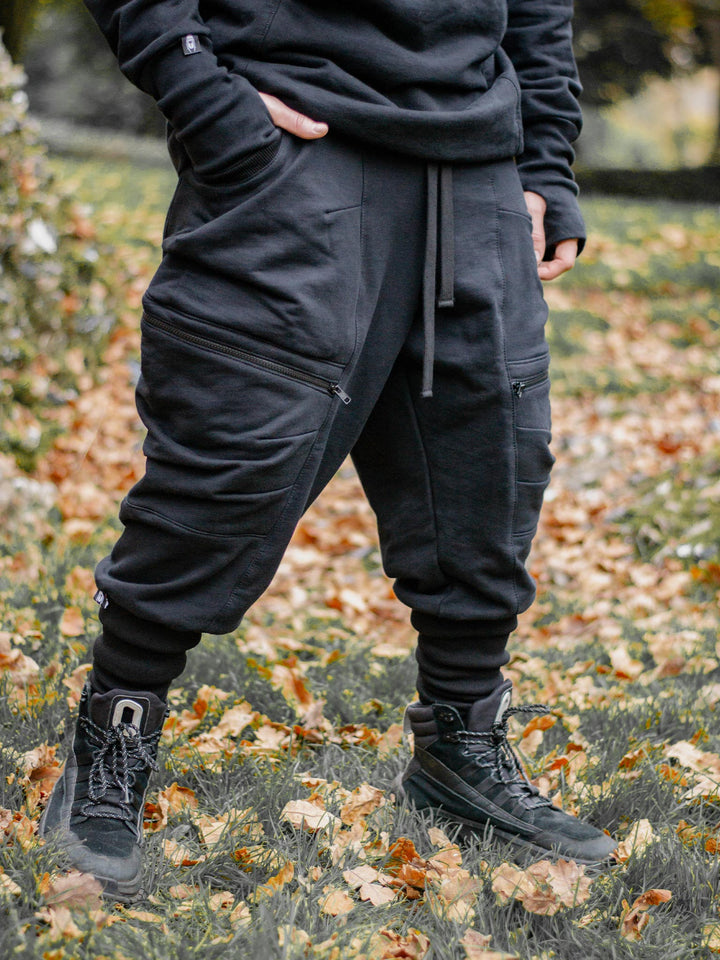 Nomadix Mens Drop Crotch Joggers with 4 Pockets Design and Calf Support in Black, made from 500gsm French Terry Loopback - image of the joggers worn outdoors