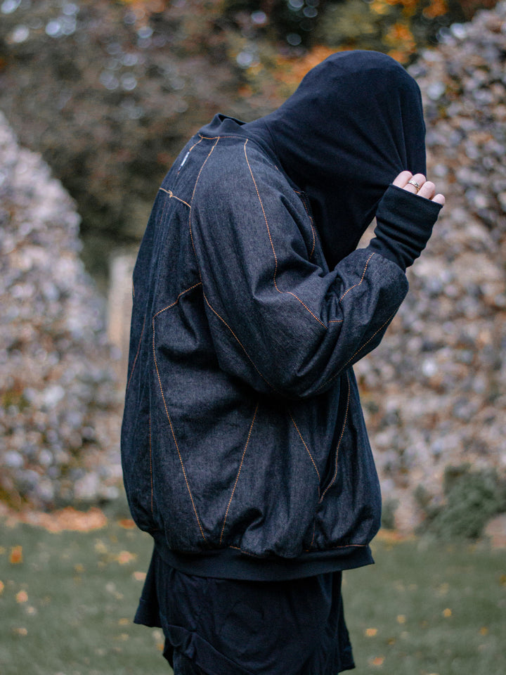 Pyros Men's Oversized Denim Bomber Jacket with Contrast Orange Stitching and Thumbholes, 2 Pockets - Side View Showing Panels and Thumbholes