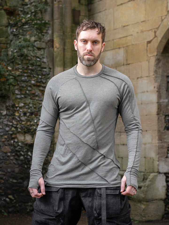 Men’s avant garde long sleeve top in Moss Grey with abstract overlock stitching, raglan sleeves, thumbholes, and longline slim silhouette. Bamboo jersey base layer - Front image