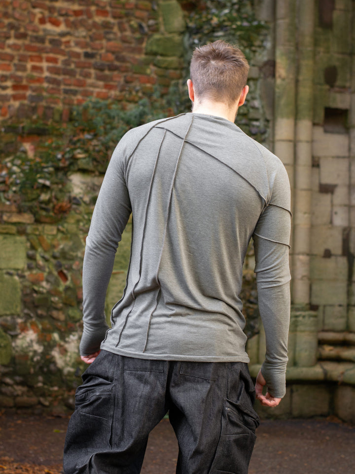 Men’s avant garde long sleeve top in Moss Grey with abstract overlock stitching, raglan sleeves, thumbholes, and longline slim silhouette. Bamboo jersey base layer - Back Image