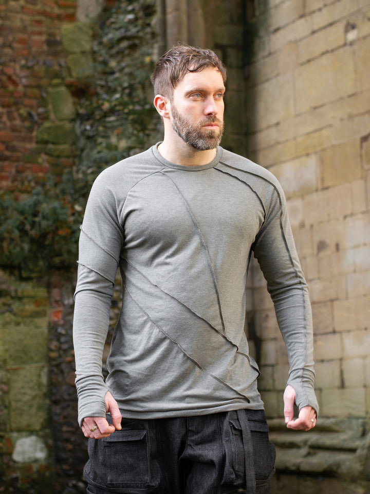 Men’s avant garde long sleeve top in Moss Grey with abstract overlock stitching, raglan sleeves, thumbholes, and longline slim silhouette. Bamboo jersey base layer - Front Image