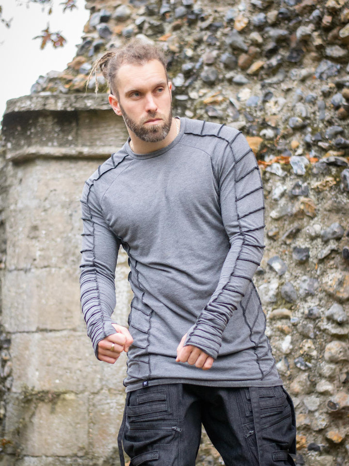 Raider Men's Longline T-Shirt with Thumbholes in Charcoal Grey, with Overlock Contrast Stitch in Black - worn by Jak showing a muscle fit