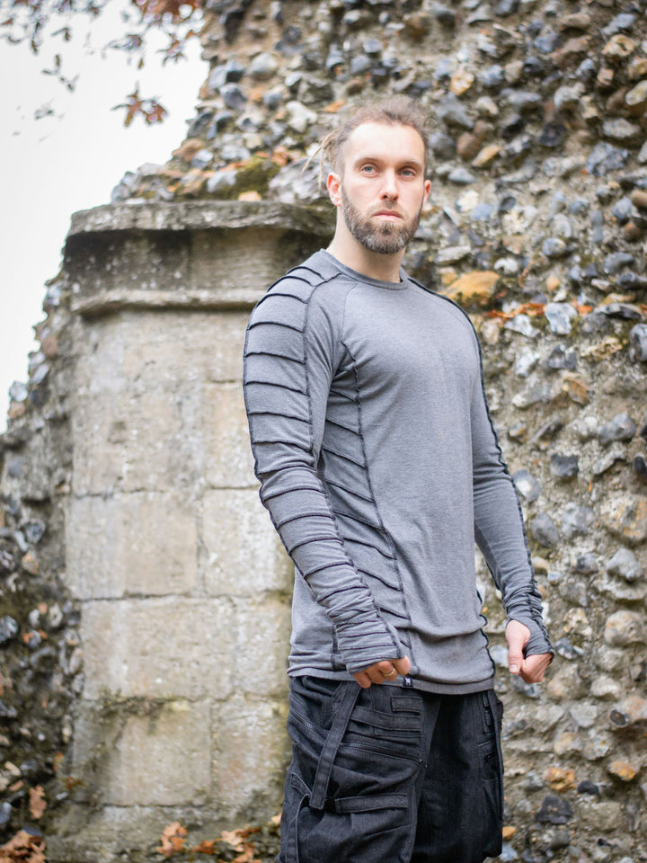 Raider Men's Longline T-Shirt with Thumbholes in Charcoal Grey, with Overlock Contrast Stitch in Black - worn by Jak and styled with the Haides Cargos