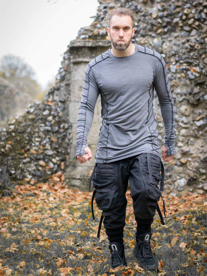 Raider Men's Longline T-Shirt with Thumbholes in Charcoal Grey, with Overlock Contrast Stitch in Black - worn by Jak and styled with the Haides Cargos