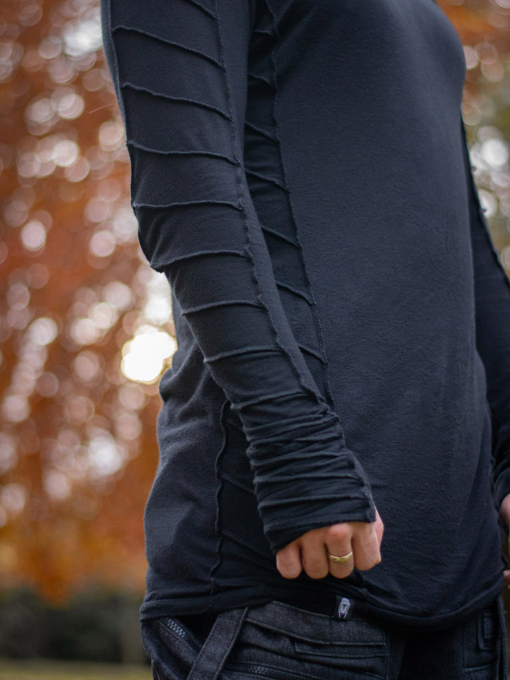 Raider black long sleeve avant-garde t-shirt with overlock stitch detailing, thumbholes, and raglan sleeves in breathable bamboo jersey – dystopian and alternative fashion style
