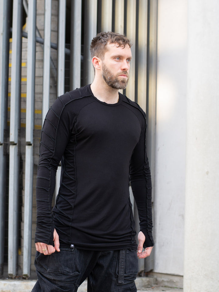 Raider black long sleeve avant-garde t-shirt with overlock stitch detailing, thumbholes, and raglan sleeves in breathable bamboo jersey – dystopian and alternative fashion style