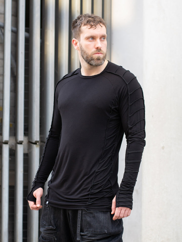 Raider black long sleeve avant-garde t-shirt with overlock stitch detailing, thumbholes, and raglan sleeves in breathable bamboo jersey – dystopian and alternative fashion style
