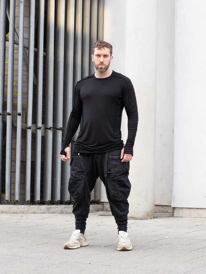 Raider black long sleeve avant-garde t-shirt with overlock stitch detailing, thumbholes, and raglan sleeves in breathable bamboo jersey – dystopian and alternative fashion style