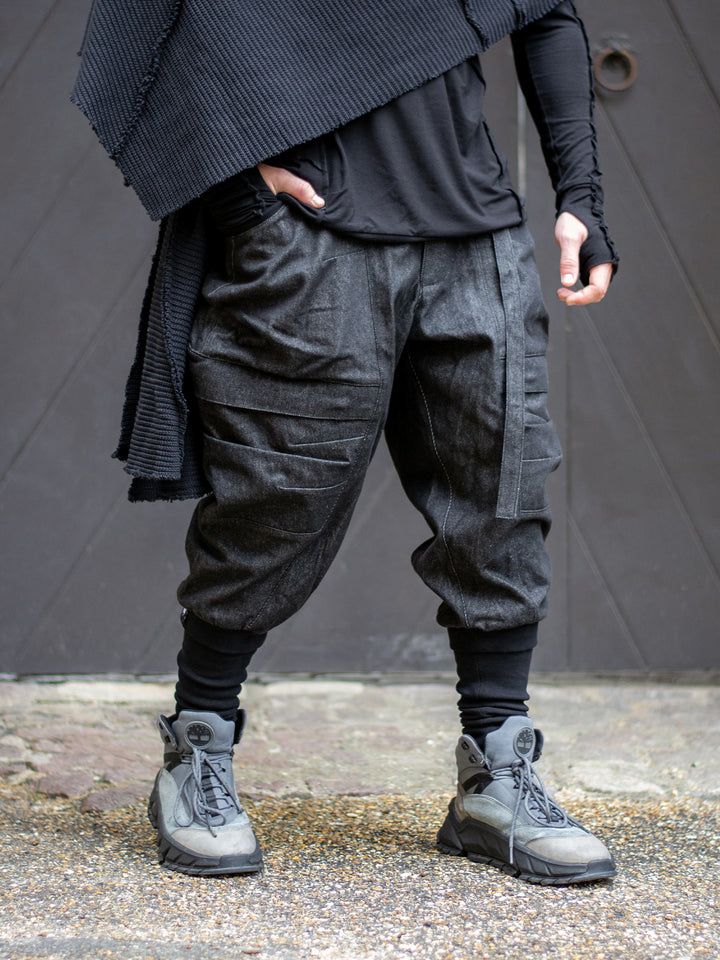 Model wearing Rhidian Cargos — designer drop crotch cargo pants in heavyweight black denim with 4-pocket design and metal hardware.