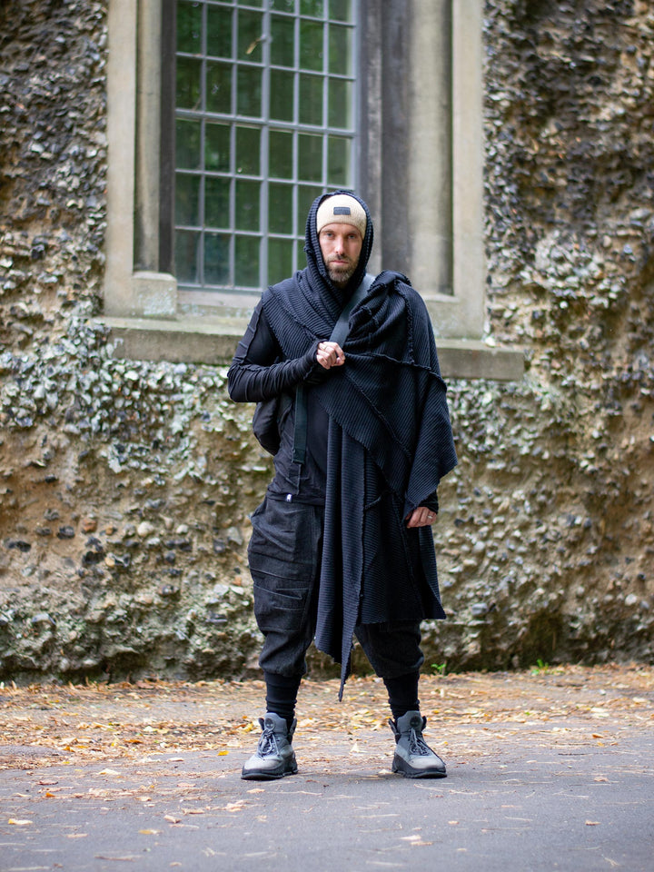 Layered avant-garde outfit featuring Rhidian denim cargo pants with Athos knit oversized scarf and utility bag — urban darkwear look.