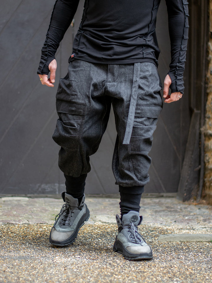 Flexible drop crotch cargo pants with articulated knee panel — relaxed fit cargo pants for movement and mobility. Rhidian avant garde cargos. 