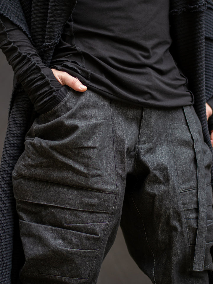 Detailed view of multi-pocket utility design — 2 hip pockets and 2 knee pockets with YKK zippers on premium denim cargo pants.