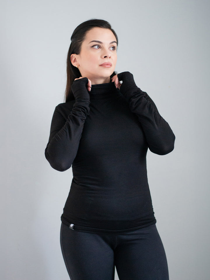 Xina Women's Roll Neck T-shirt with Thumboles in Black. A slimline silhouette with long sleeves and functional thumbholes for both casual and active styles. 