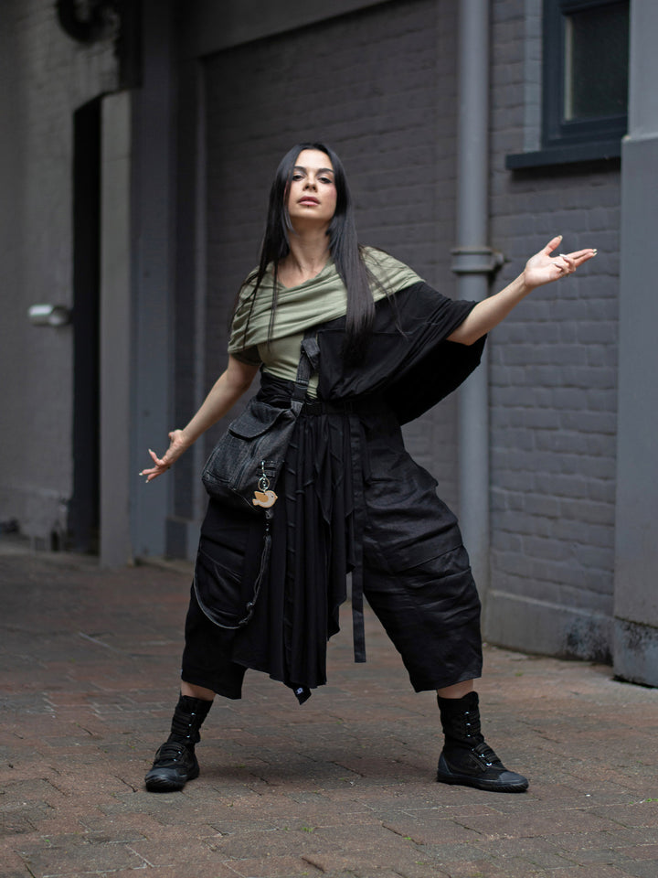 Model wearing Yara sage green short sleeve hooded t-shirt in bamboo jersey, with soft drape, double-layer hood, and fitted silhouette — alternative designer streetwear by Rags by Jak.