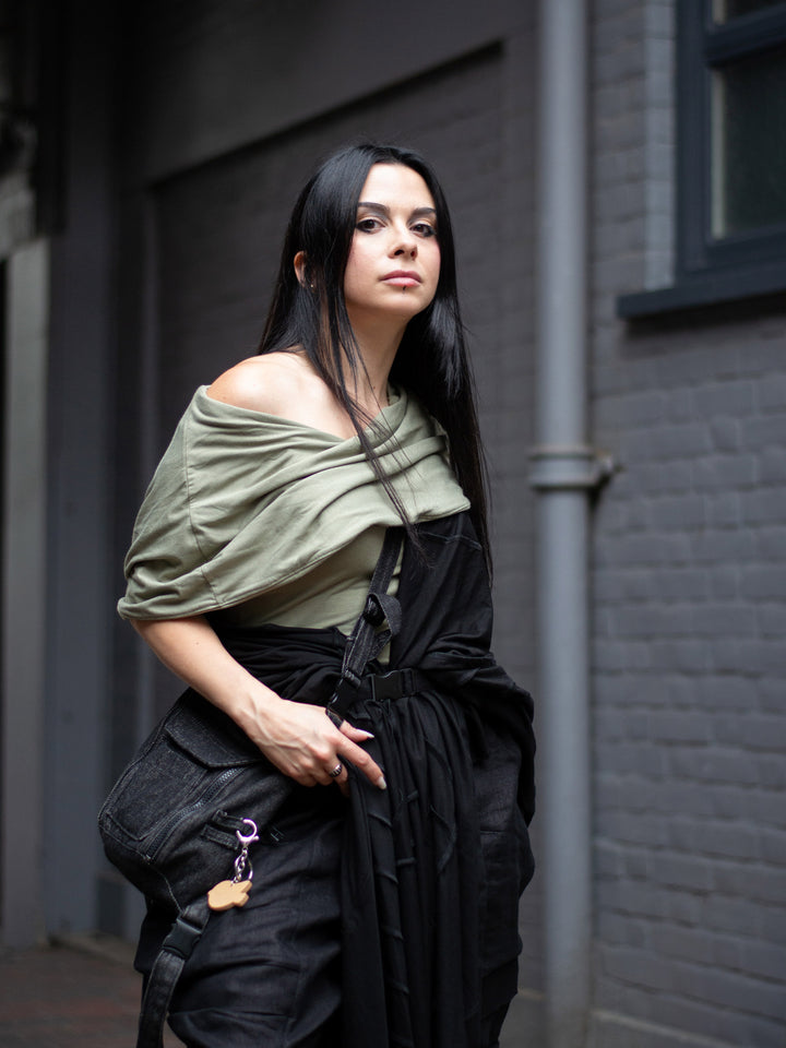 Model wearing Yara sage green short sleeve hooded t-shirt in bamboo jersey, with soft drape, double-layer hood, and fitted silhouette — alternative designer streetwear by Rags by Jak.