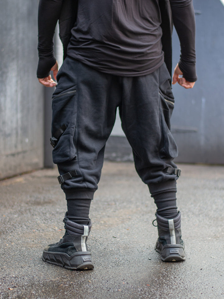 Zye Men's Drop Crotch Joggers in Black, featuring Straps and Buckles, and a functional 4 pockets design. Tactical techwear style pants. 