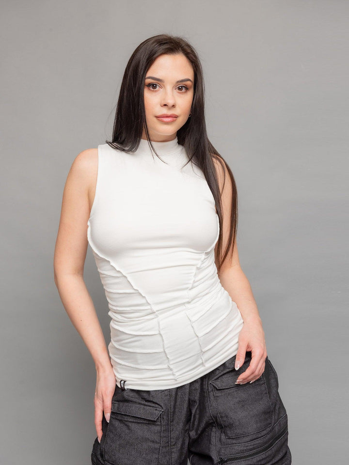 Kira high neck tank top in white with a body hugging silhouette and overlock stitch details on the waist sides for an hourglass effect - front view close-up