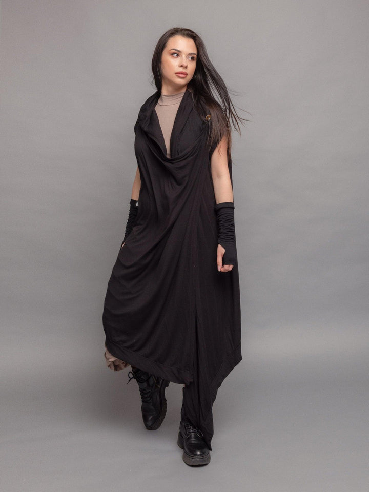 Medina avant garde cloak with hood, wrap-over design with draped effect and asymmetric hem in black - walking pose