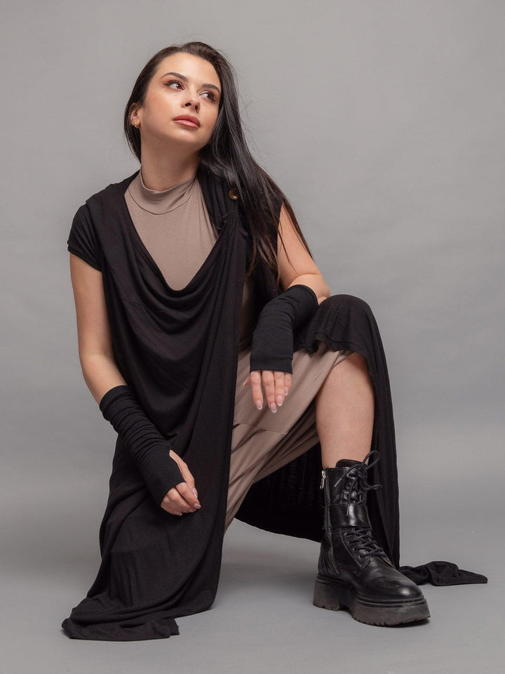 Medina avant garde cloak with hood, wrap-over design with draped effect and asymmetric hem in black - close-up pose