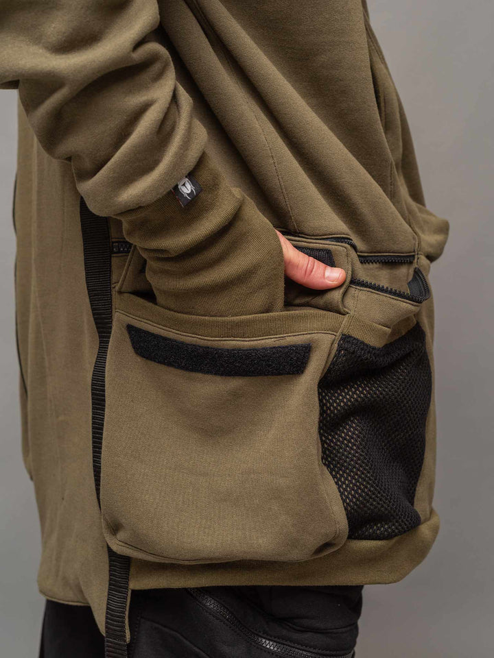 Focus shot of the back side flap pocket with velcro of the Colossus Hoodie.
