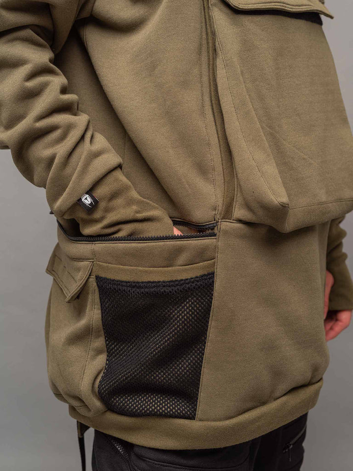 Focus shot of the side zipped pocket of the Colossus Hoodie in Olive Green.