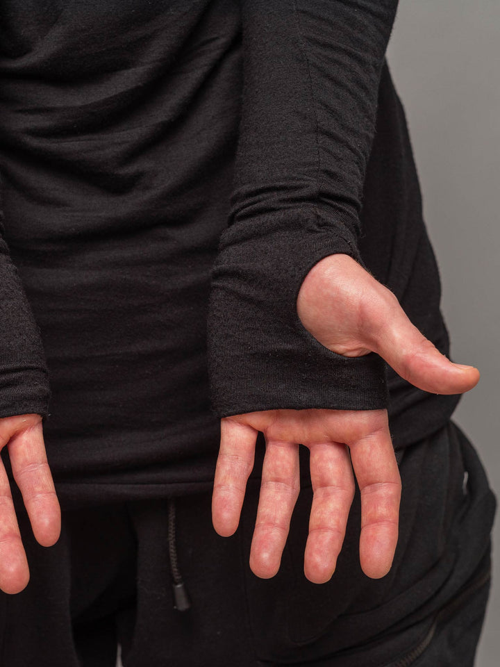 Close up view of the thumbholes with the palms open, from the Fusion long sleeve t-shirt in black.