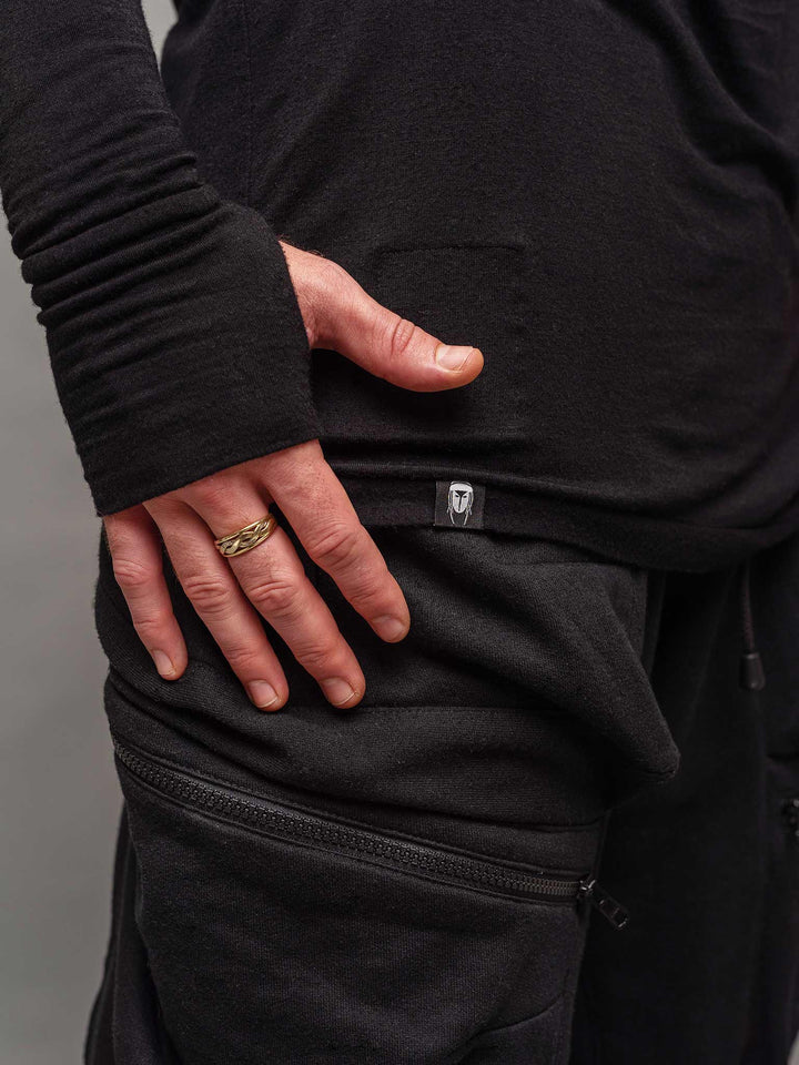 Close up view of the thumbholes from the Fusion long sleeve t-shirt in black.