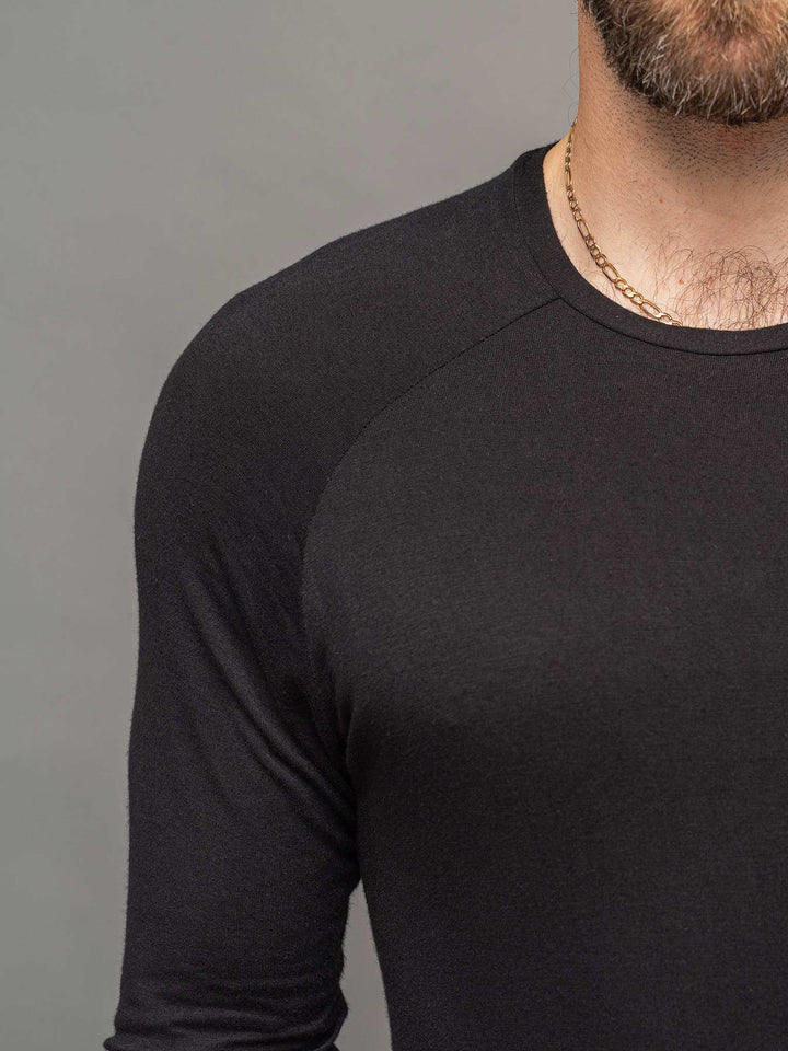 Close up view of the raglan sleeve detail, from the Fusion long sleeve t-shirt in black.