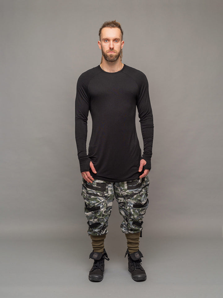 Full body view of the Fusion long sleeve t-shirt in black, styles with the Stealth cargo Pants.