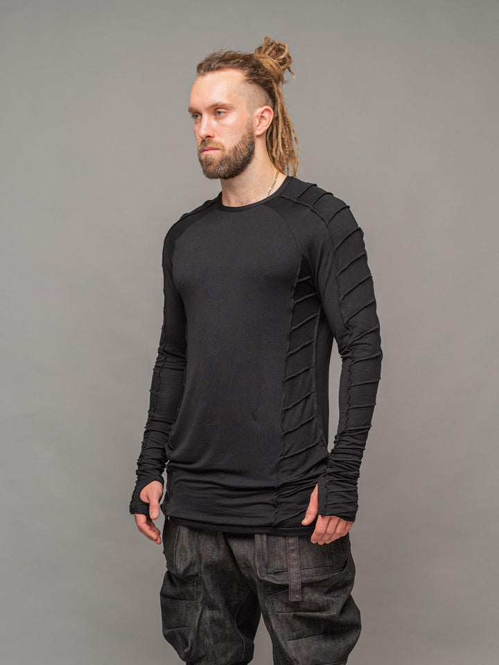 Raider dystopian men's longline tshirt with thumboles and overlock stitch details in black - left side pose
