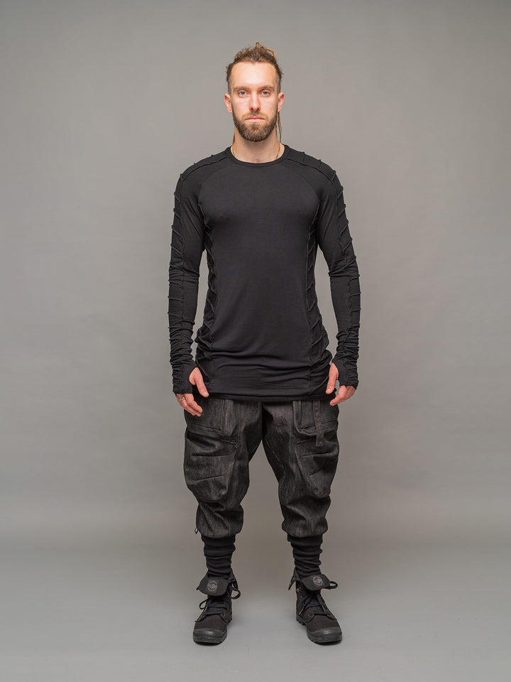 Raider dystopian men's longline tshirt with thumboles and overlock stitch details in black - full body view styled with the Warlock Cargos