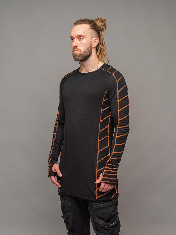Raider dystopian avant garde men's longline tshirt in black with thumbholes and overlock contrast stitch in orange - left side view