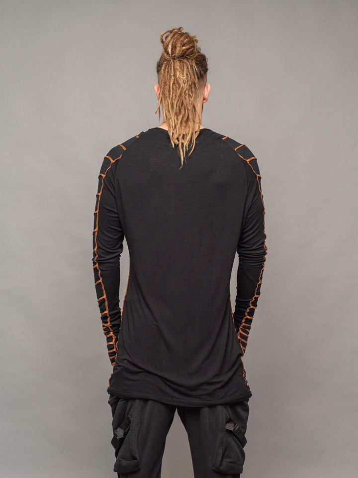Raider dystopian avant garde men's longline tshirt in black with thumbholes and overlock contrast stitch in orange - back view