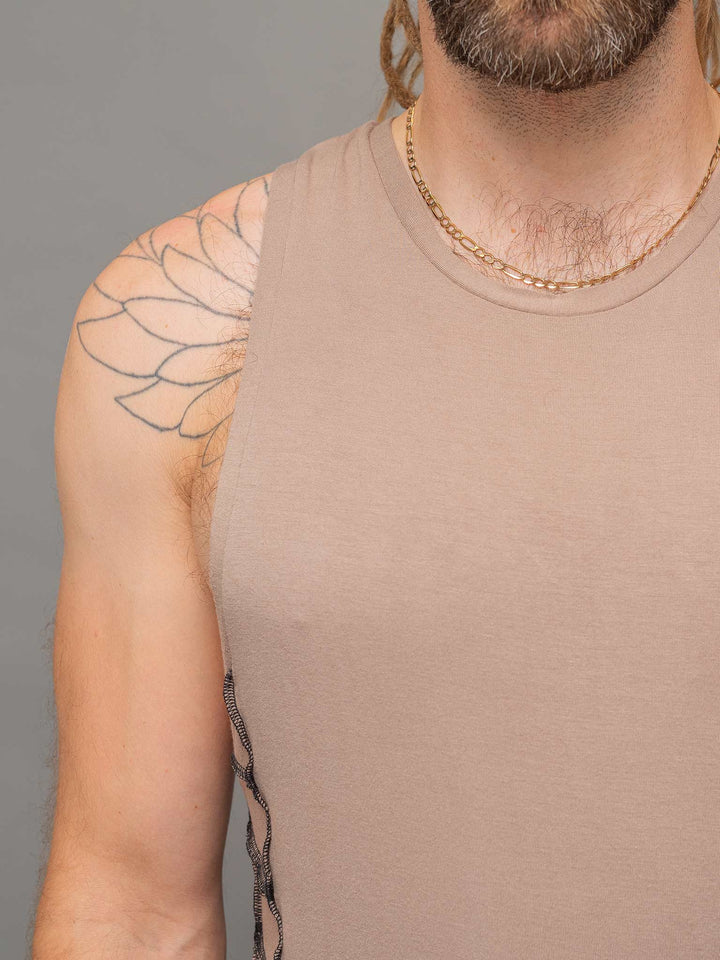 Close up view of the neckline of the Raider vest in Taupe with black stitching.