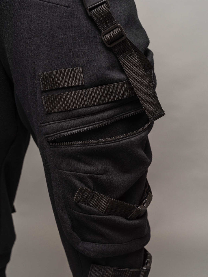 Close up zipped pocket view with the pocket open of the Renegade joggers in black.