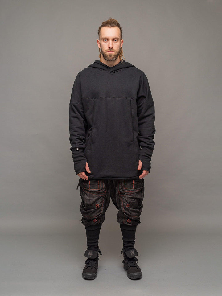 Full body view of the Titan hoodie in black, styled with the Kraken cargo pants