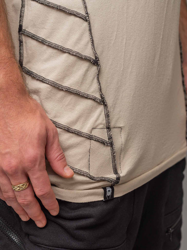 Hem and label view of the Raider short sleeve t-shirt in sand with black stitching.