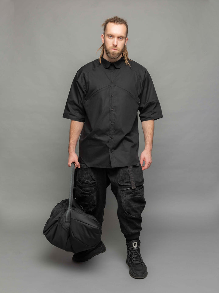 apex oversized poplin short sleeve shirt with geometric panelled design and hidden zips - Full body pose paired with encke duffle bag