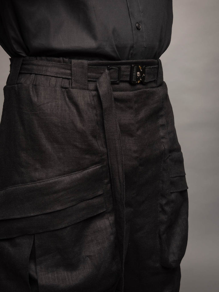 Zyrex drop crotch knee length shorts in sand with 8 pocket design - Front belt loop view paired with a linen belt