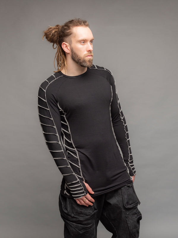 Raider dystopian longline tshirt in black with thumbholes and contrast overlock stitch details in grey - front pose