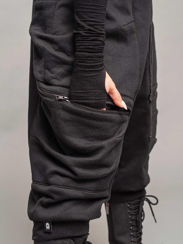 women's drop crotch joggers in black, relaxed wide fit, YKK zipped pockets, elasticated waistband with drawstring close-up view pockets